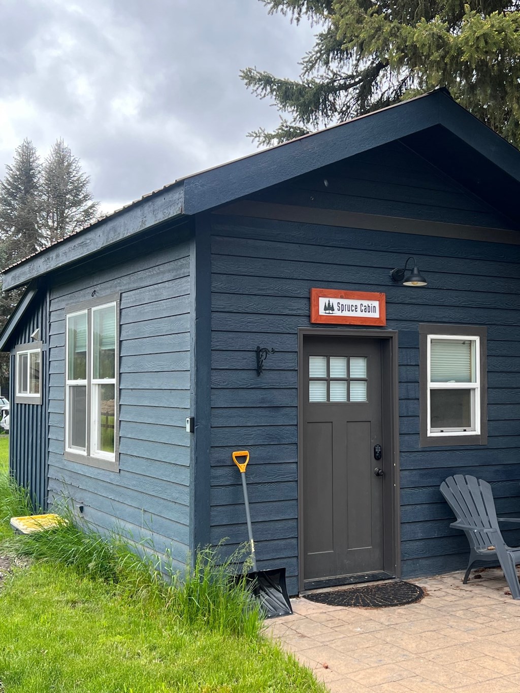 a blue building with a door and a sign on the side of it