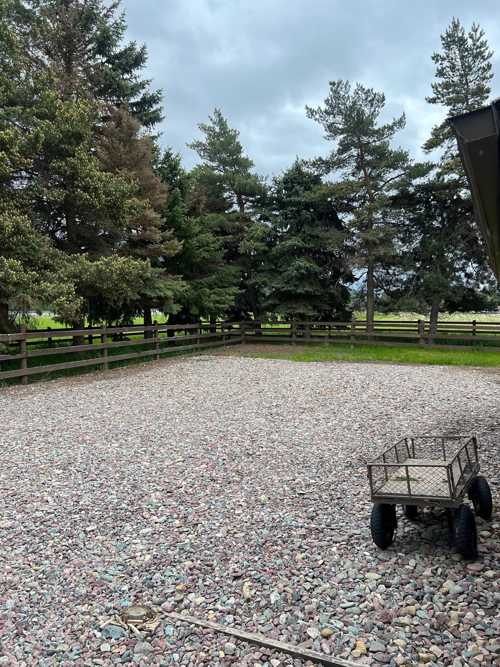 a wagon sitting in the middle of a gravel parking lot