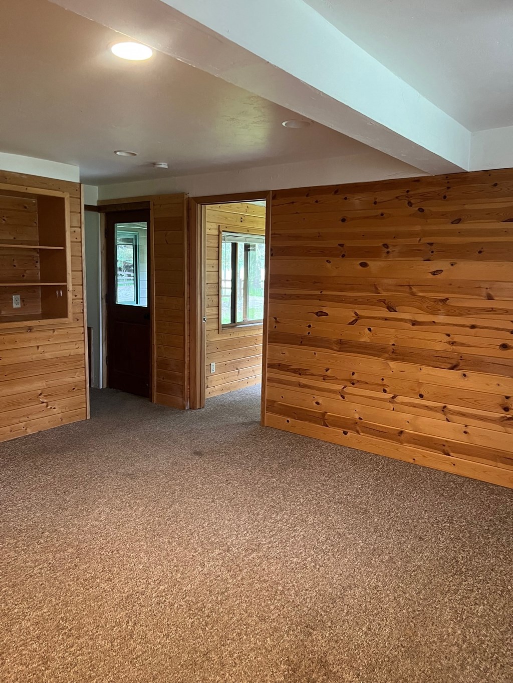 a living room with a wooden wall in a house