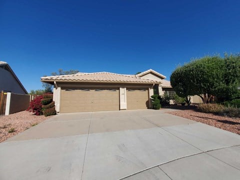 a garage door with a driveway in front of a house