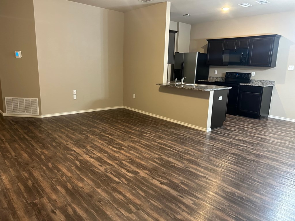 A kitchen area with a counter and appliances.