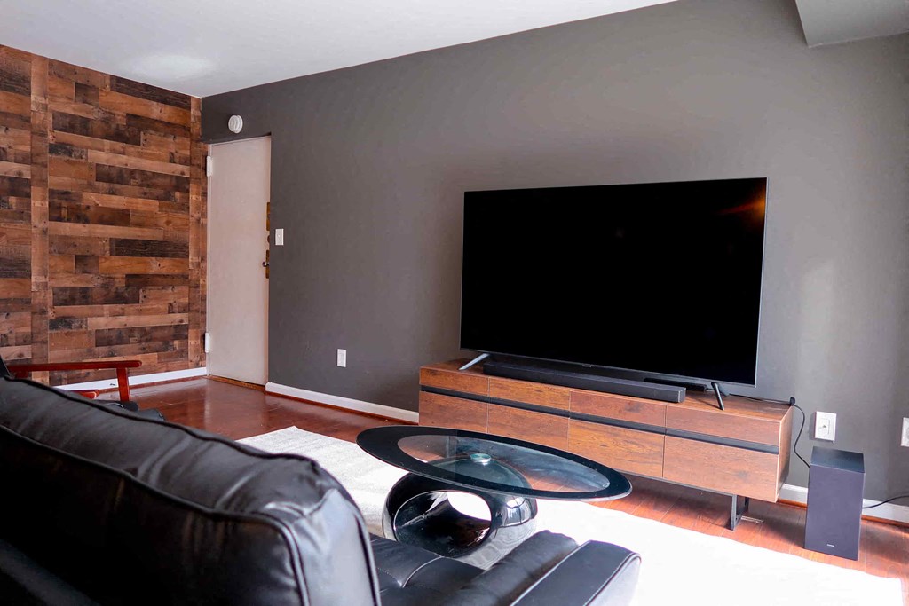 a living room with a tv and a leather couch