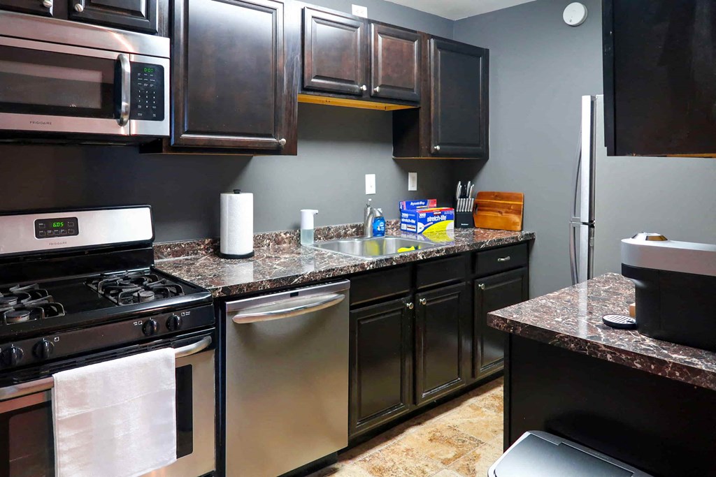 a kitchen with stainless steel appliances and granite counter tops