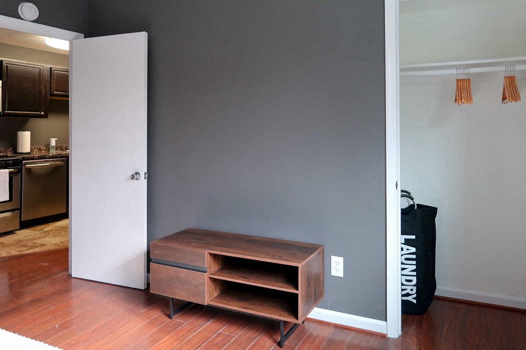 a room with an open door and a wooden table