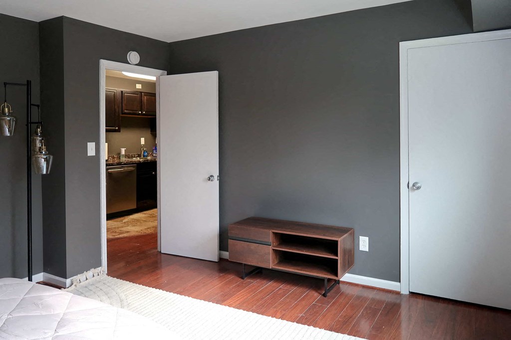 a living room with a couch and a door to a kitchen