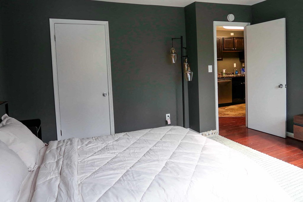 a bedroom with a large white bed and two doors