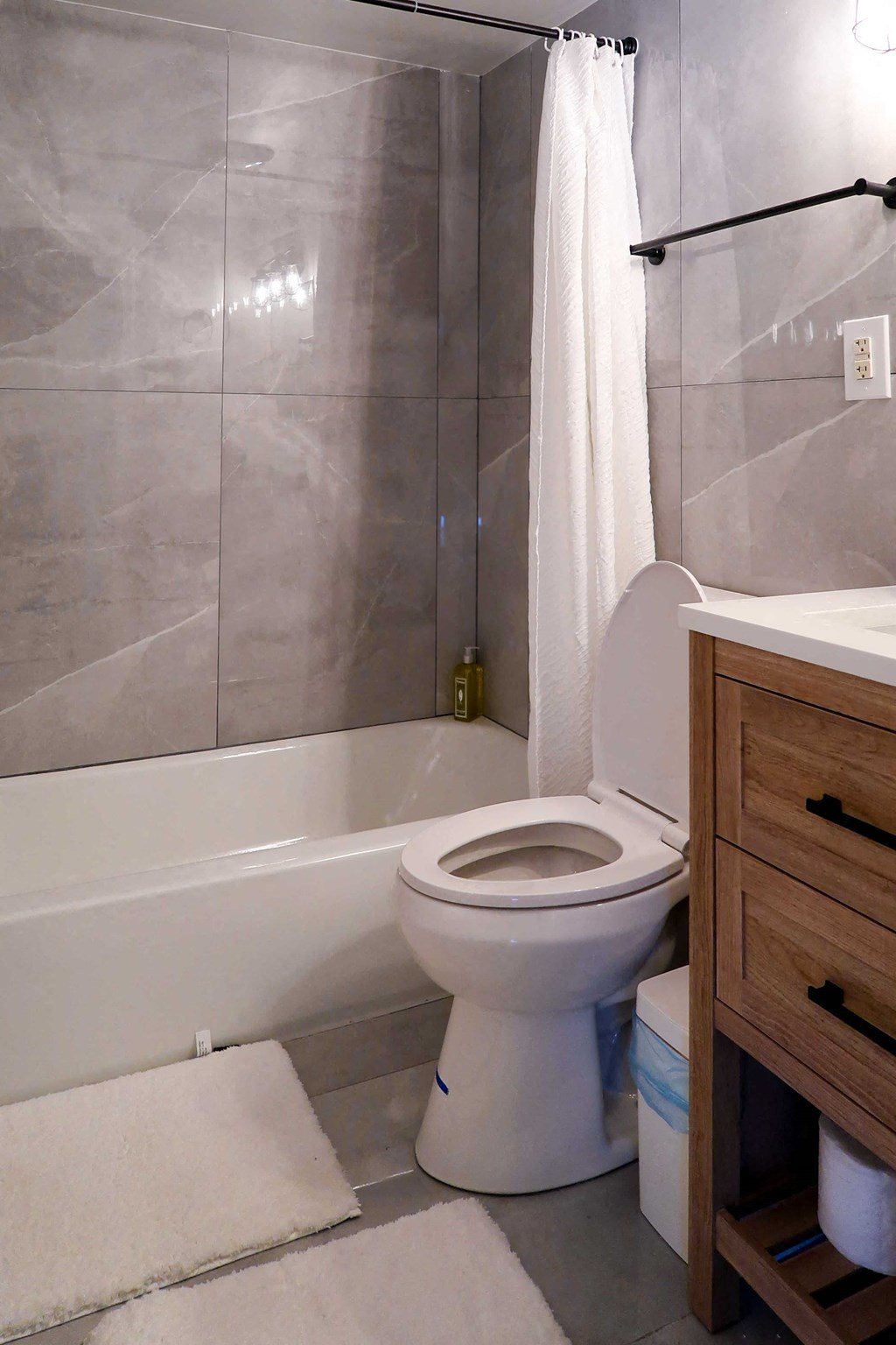 a bathroom with a toilet and a tub and a sink