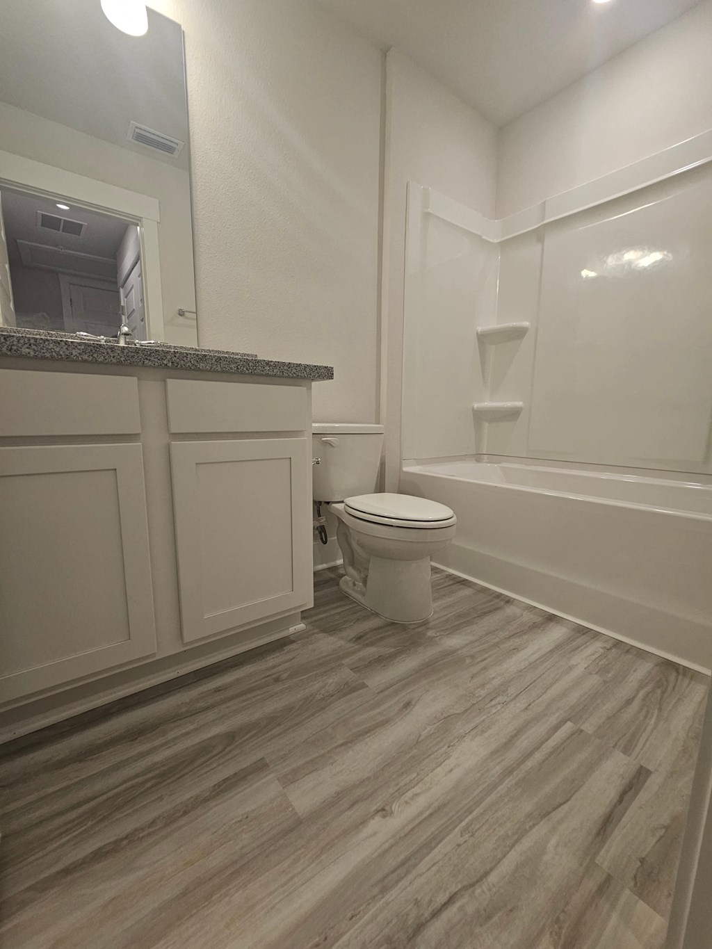 a bathroom with a toilet and a sink and a bath tub