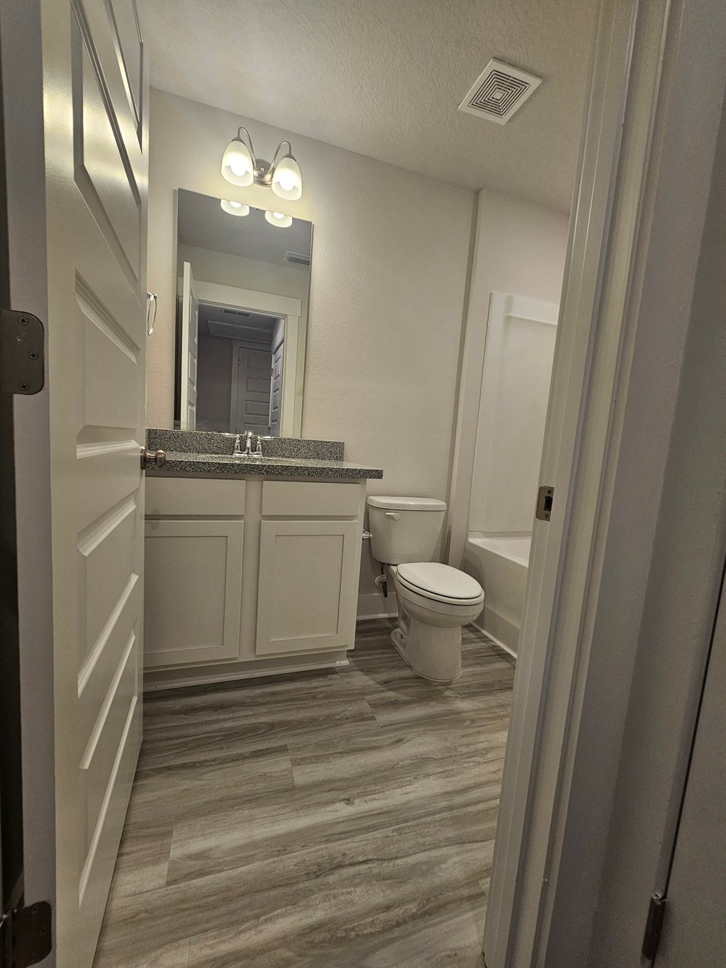 a bathroom with a toilet and a sink and a mirror