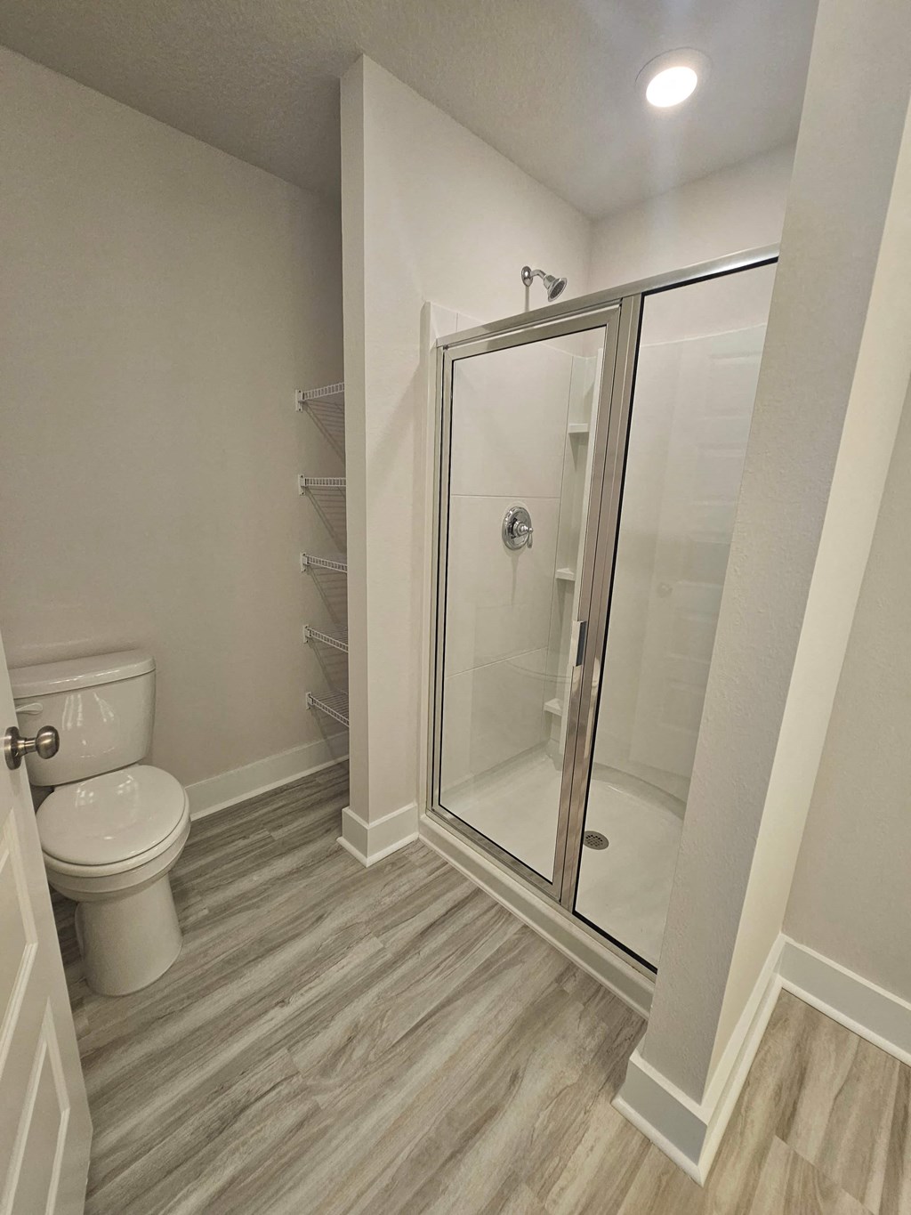 a bathroom with a toilet and a shower