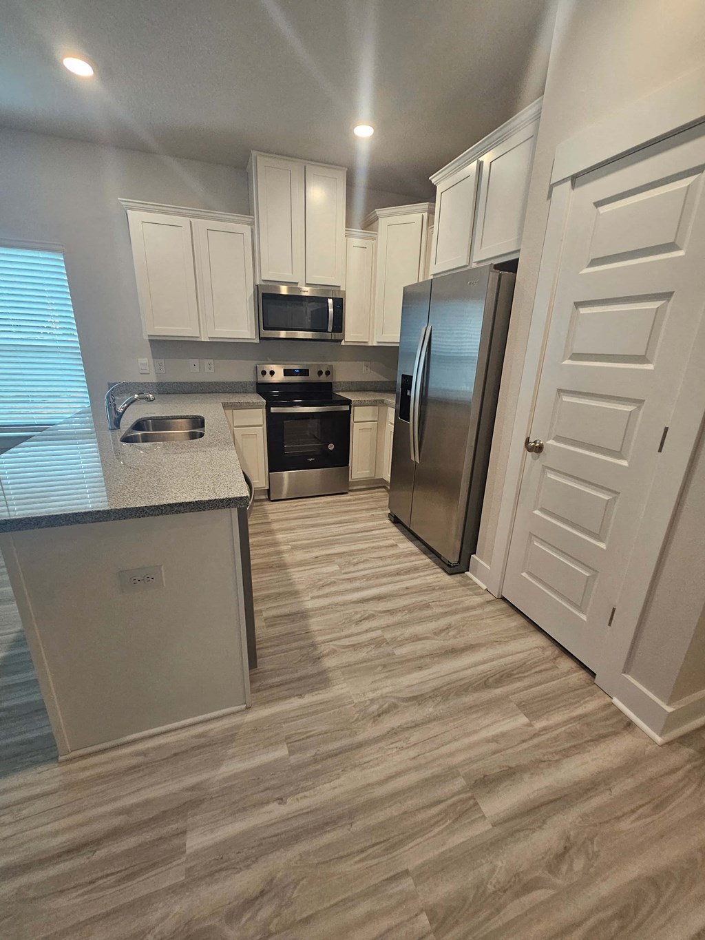 a kitchen with stainless steel appliances and white cabinets