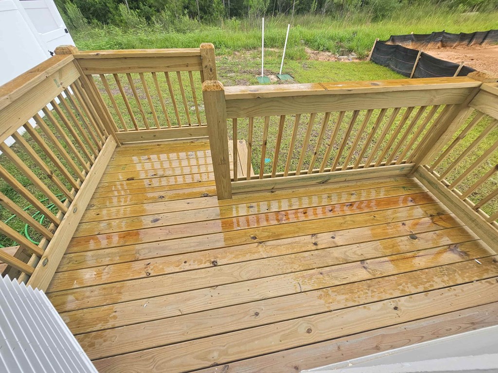 a deck with a wooden floor and a fence