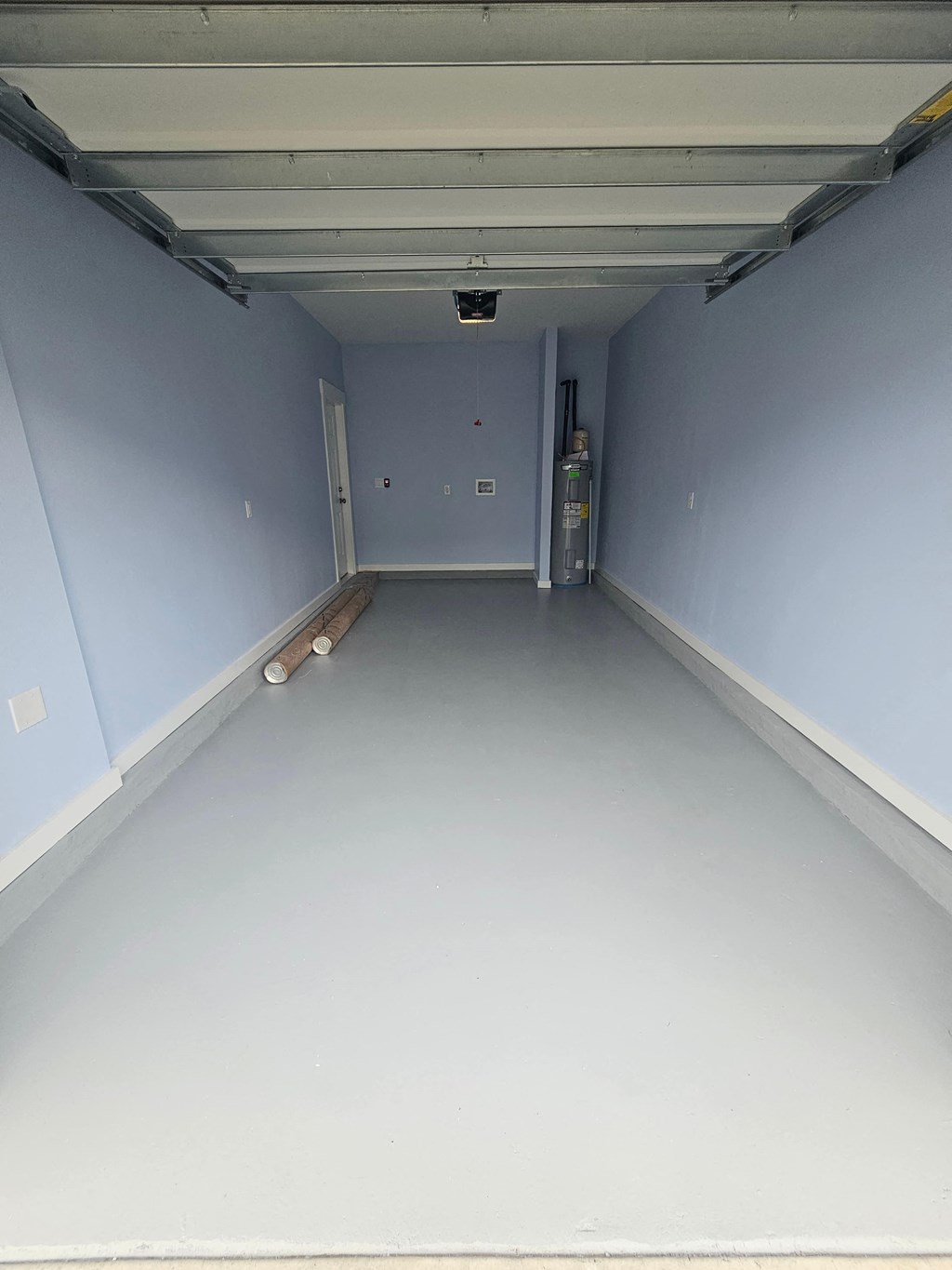 a garage with a white floor and blue walls