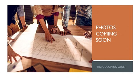 a group of people looking at plans on a table