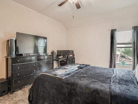 a bedroom with a bed and a tv in it