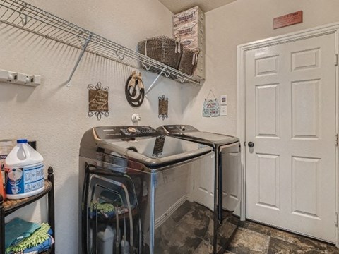 a small kitchen with a stove and a door