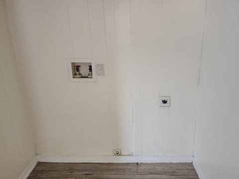 the wall of a room with a light switch on the wall