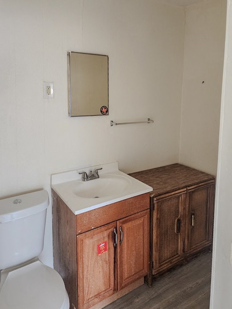 a bathroom with a sink toilet and a mirror