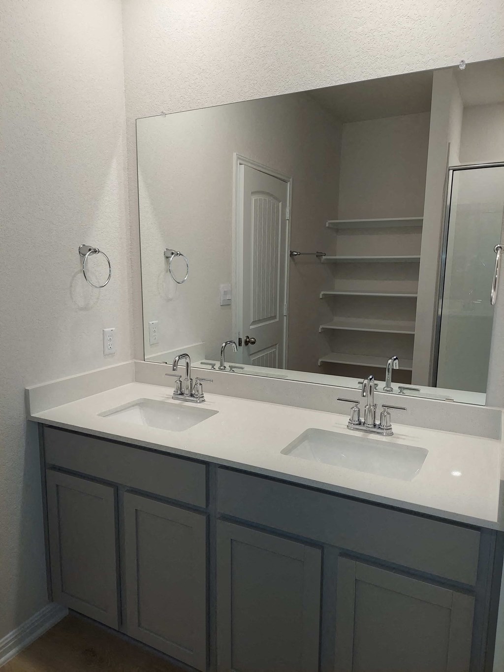 a bathroom with two sinks and a large mirror