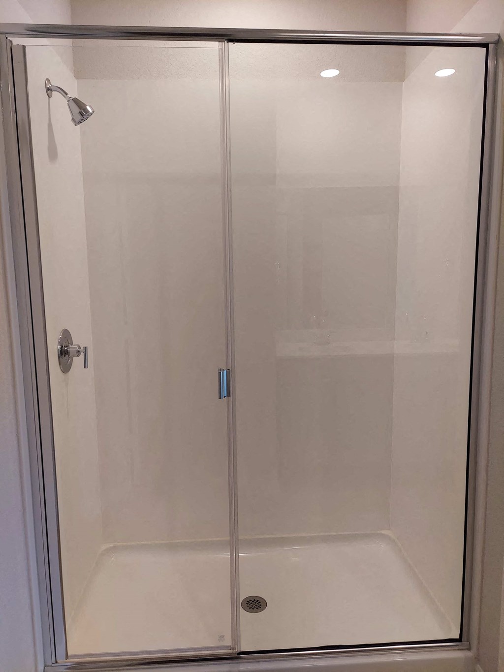a shower in a bathroom with a glass door