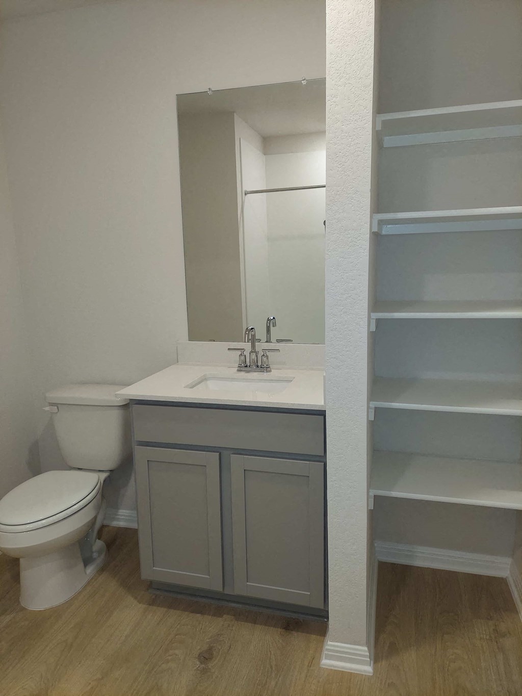 a bathroom with a toilet sink and a mirror