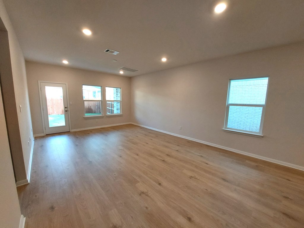 a living room with a hard wood floor and a window