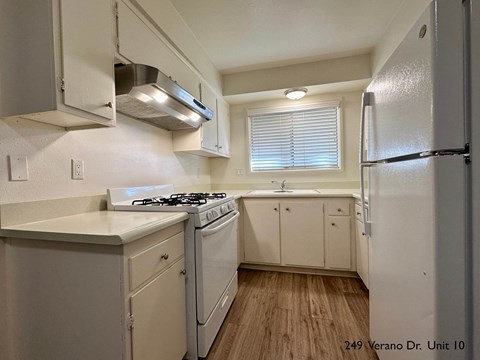 a kitchen with white appliances and white cabinets
