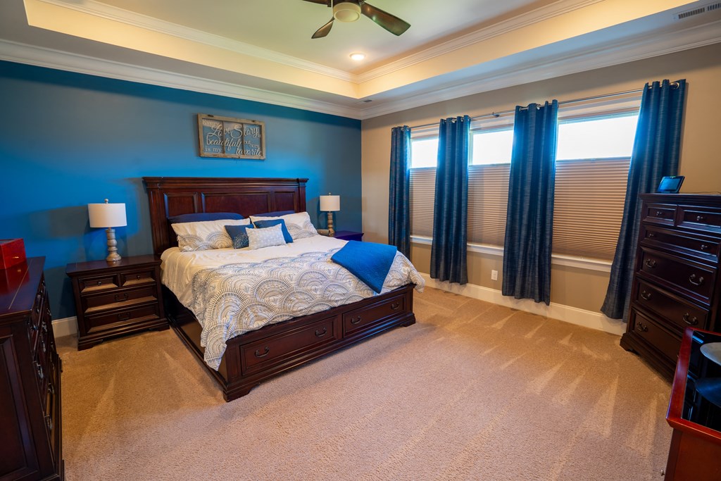 a bedroom with a bed and two dressers