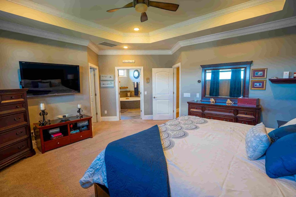 a large bedroom with a large bed and a large tv