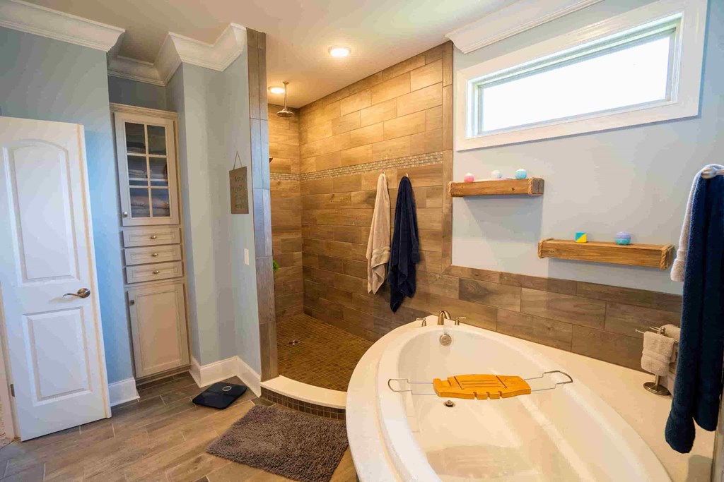 a large bathroom with a large tub and a shower