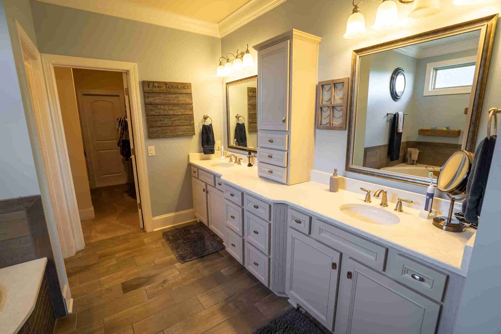 a large bathroom with two sinks and a mirror