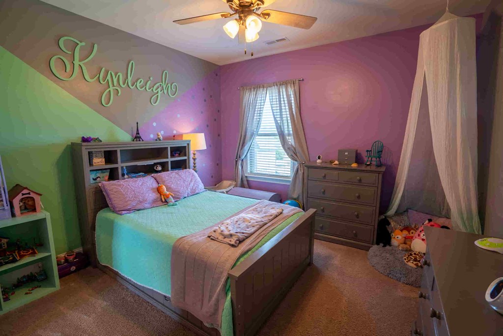 a bedroom with a bed and a dresser