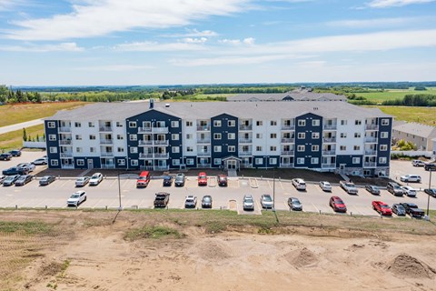 A large building with a parking lot in front of it.