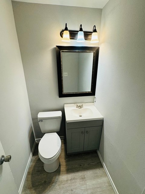 a small bathroom with a toilet sink and mirror