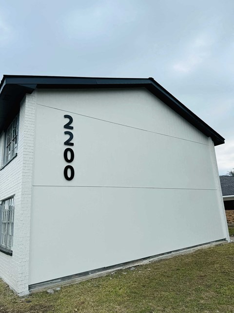 the side of a building with numbers on it