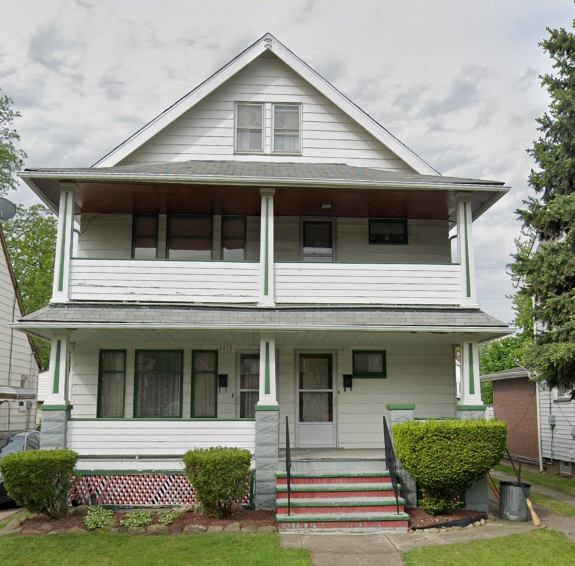 a white house with a porch and