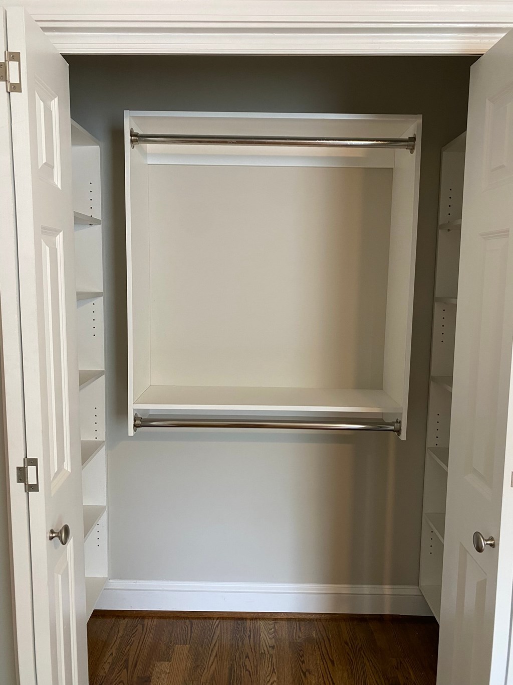 a closet with a window and a wood floor