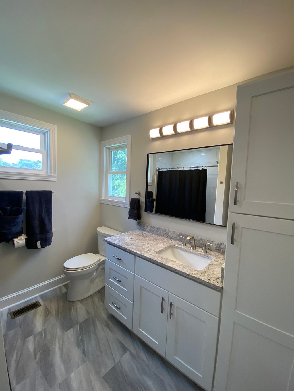 a bathroom with a toilet and a sink and a mirror