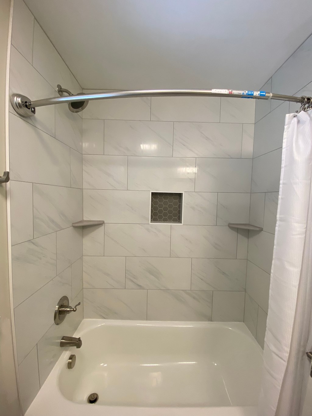 the shower in our bathroom has a shower curtain