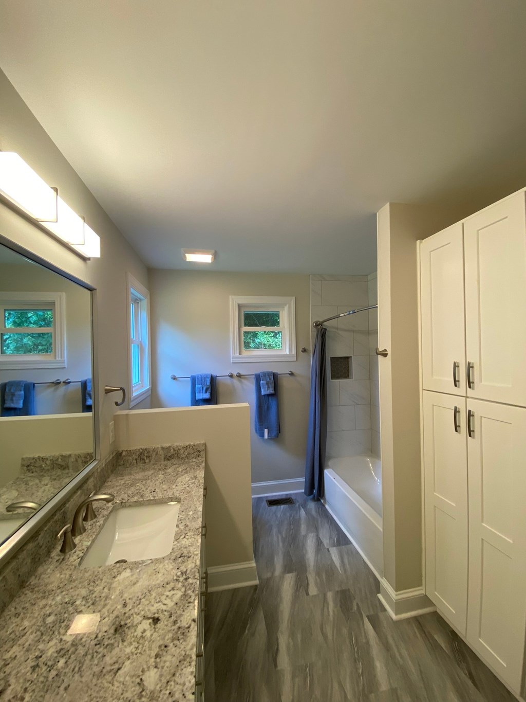 a view of a bathroom with a sink and a tub and a shower