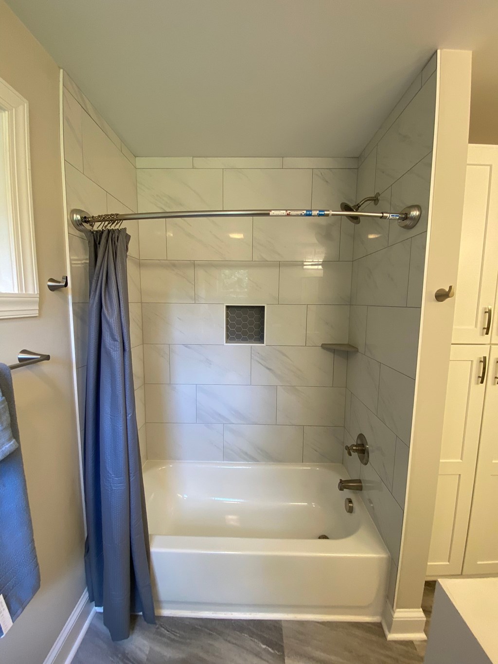 a small bathroom with a tub and a shower curtain