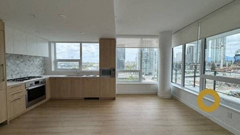 a kitchen with a stove and a large window