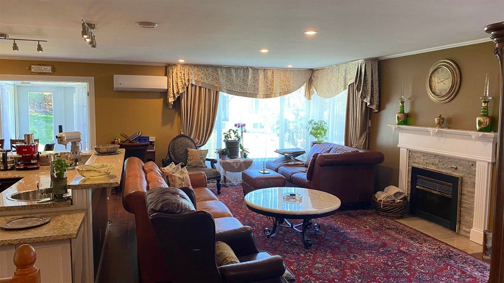 a living room with couches and chairs and a fireplace