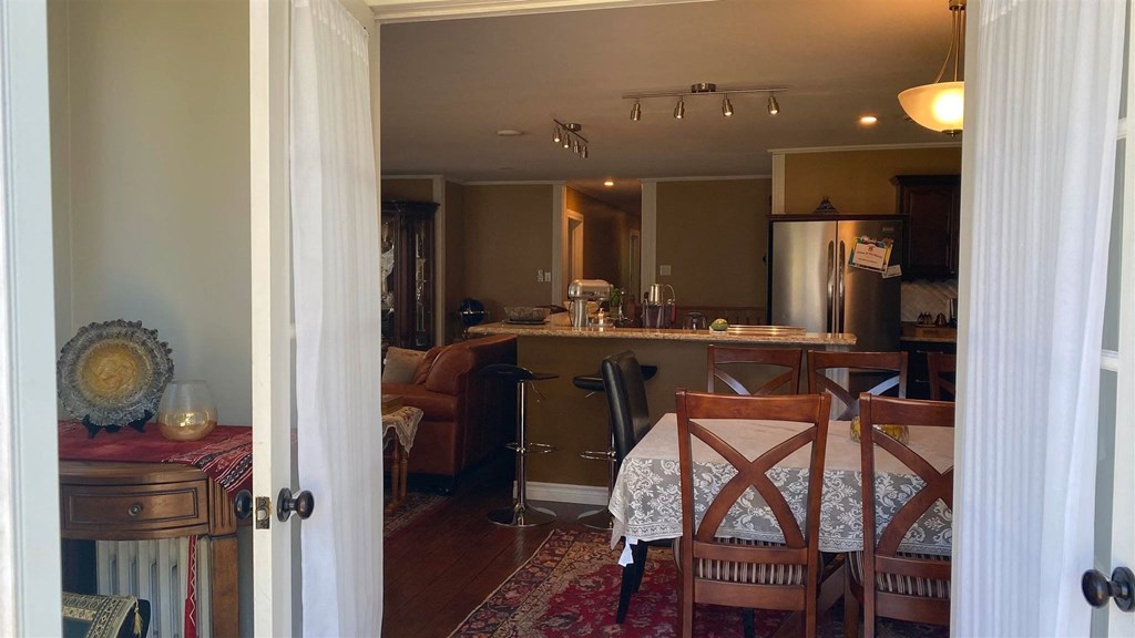 the view from the dining room into the kitchen and living room