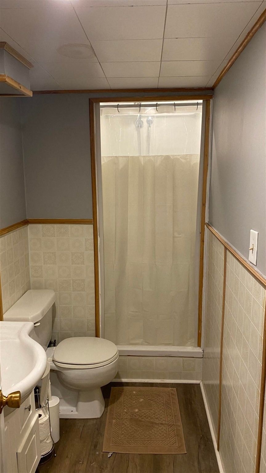 a bathroom with a toilet and a shower