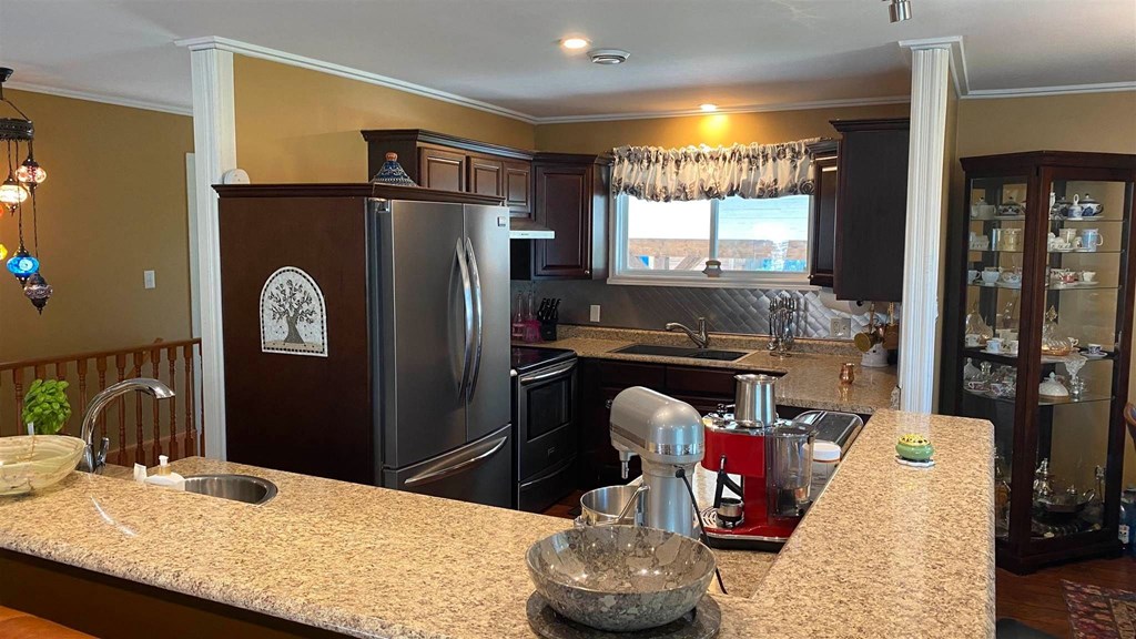 a kitchen with stainless steel appliances and granite counter tops