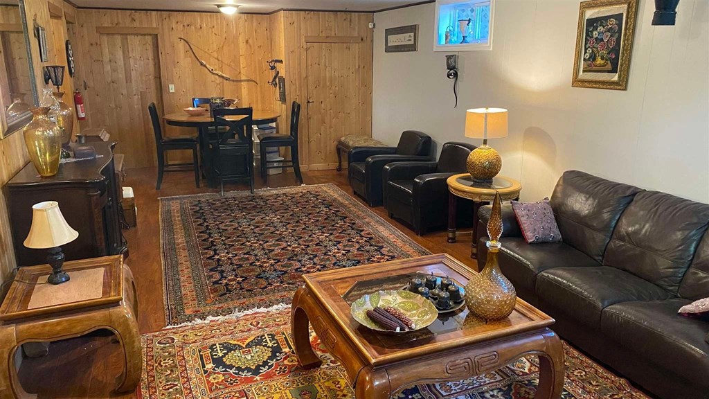 a living room with leather furniture and a rug
