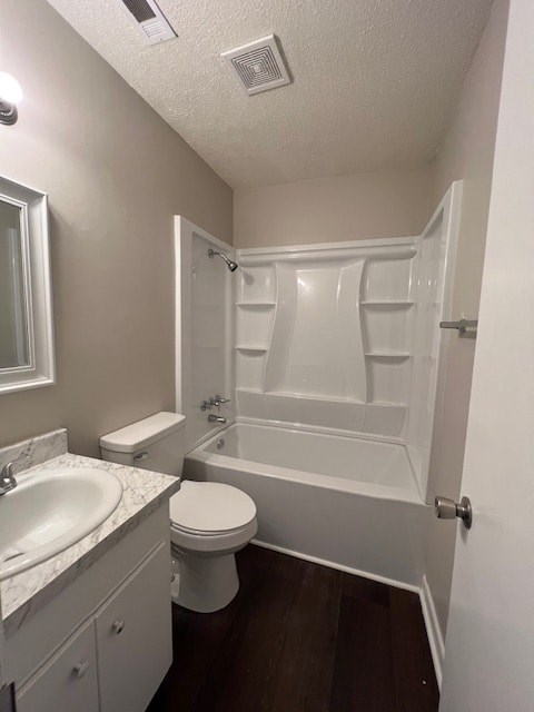 a bathroom with a toilet and a tub and a sink