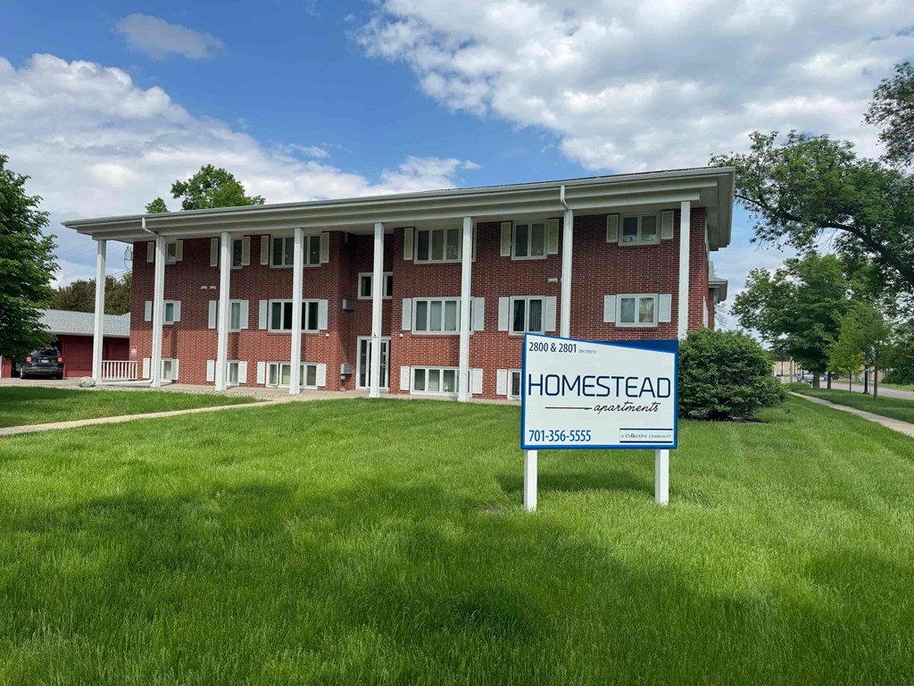 a home sold sign in front of a building