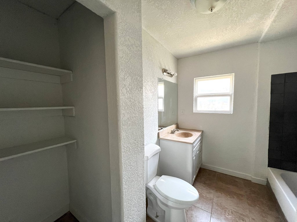 an empty bathroom with a toilet and a sink